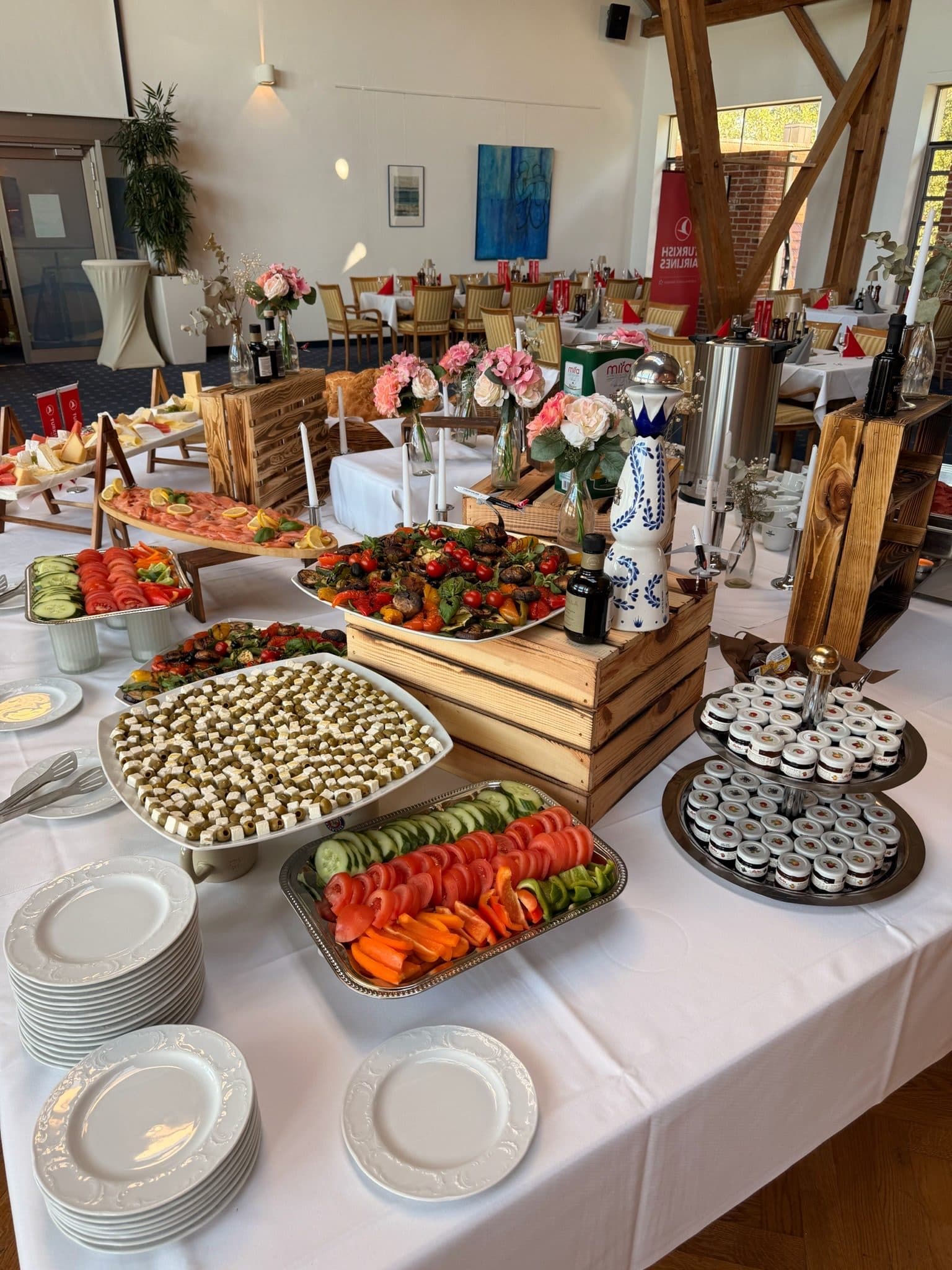 A buffet of antipasti, vegetables and finger food in wooden crates in the dining room