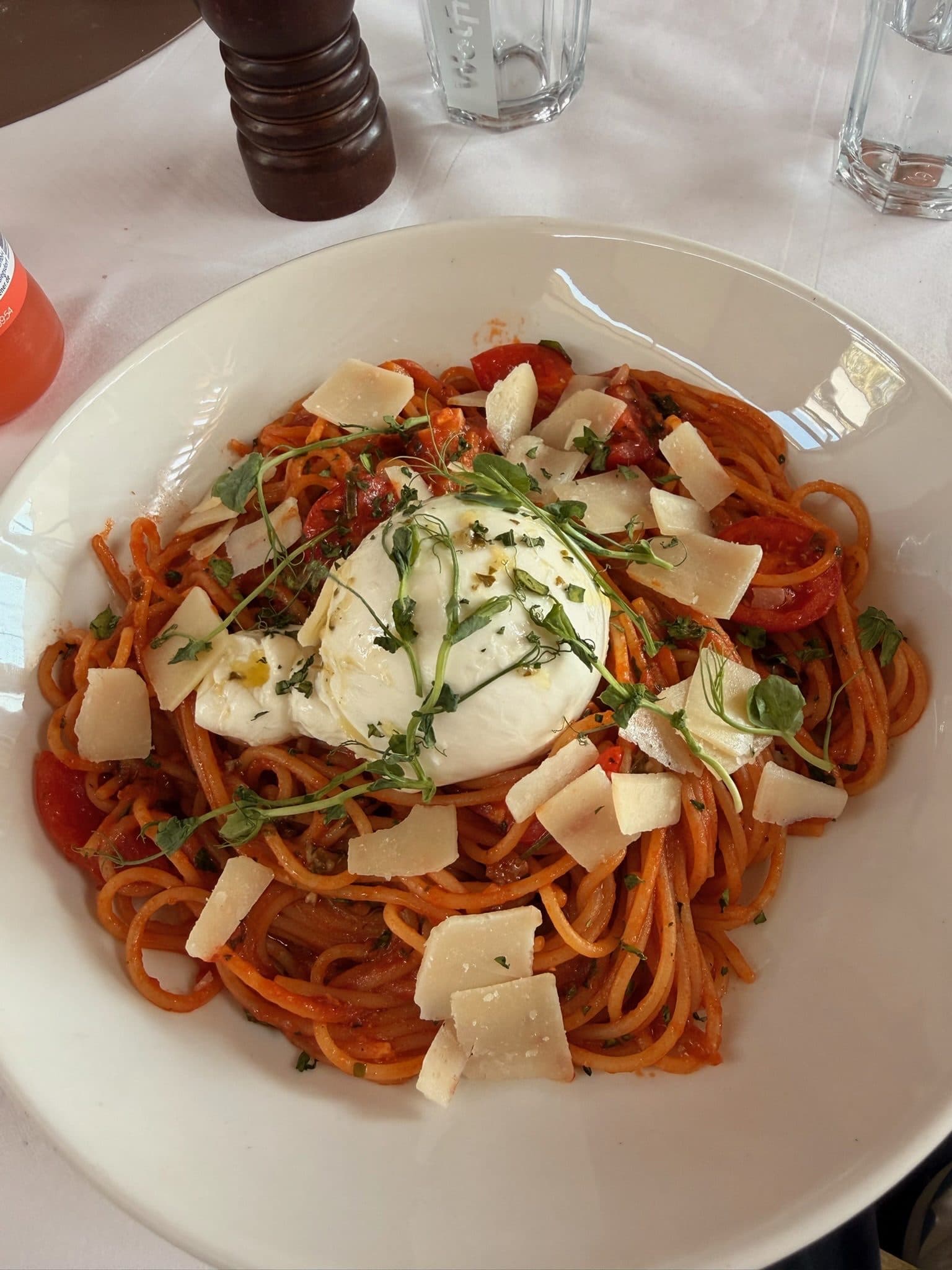 Spaghetti in Tomatensauce mit Burrata und gehobeltem Parmesan